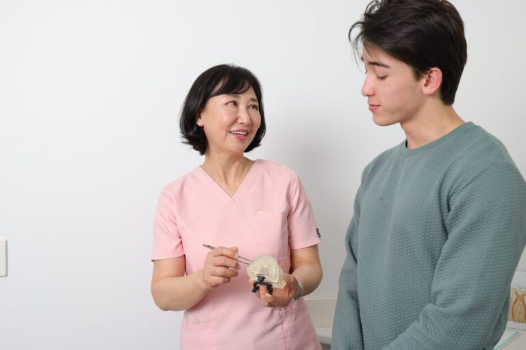 Dentist explaining a treatment with a dental model