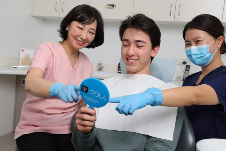 Dentist and nurse with a smiling patient at Aesthetic Mee Dental Ashburton