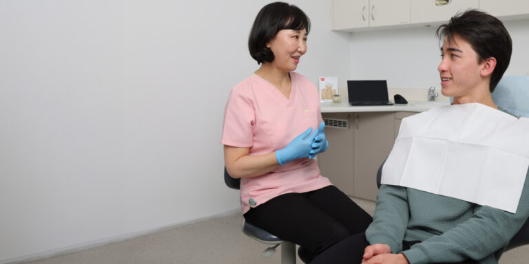 Dentist talking with a patient in the treatment room