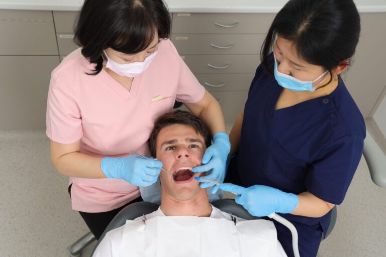 Dentist and dental assistant treating a patient